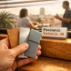 Primer plano extremo de una mano técnica mostrando muestras de materiales en un entorno cálido y acogedor en Valencia. Cual es la empresa de instalacion de persianas mas popular en Valencia.